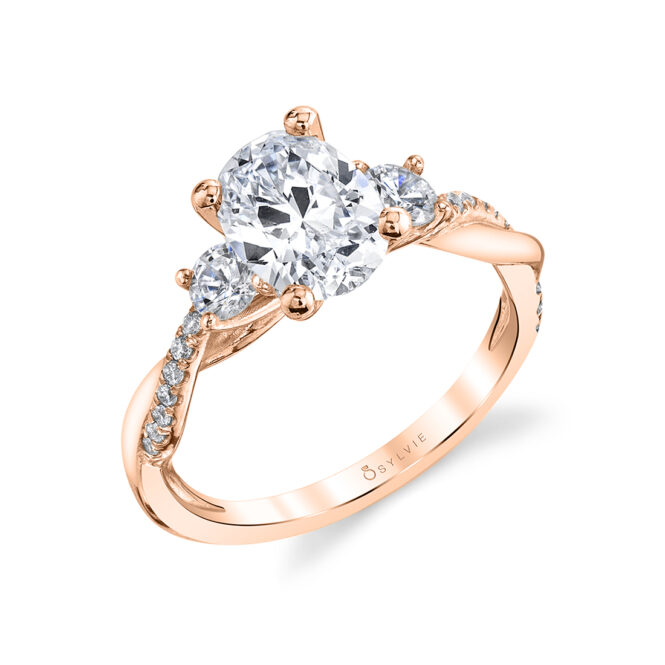 3 stone oval engagement ring with round side stones shown in rose gold - Style 