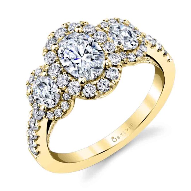 oval halo engagement ring with three stones in yellow gold