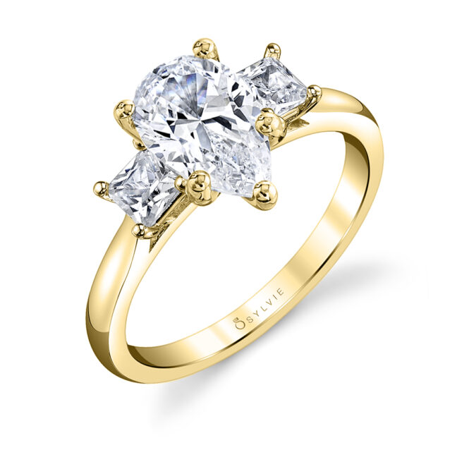 pear cut ring with princess cut side stones in yellow gold