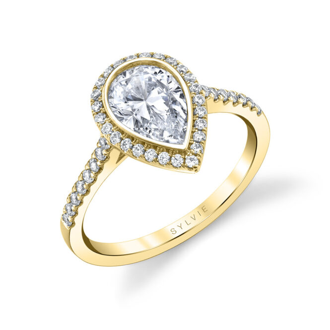 pear shaped bezel set engagement ring in yellow gold